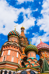 Fototapeta na wymiar St. Basil's Cathedral, a blue sky with clouds - a view from below