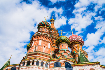 Fototapeta na wymiar St. Basil's Cathedral, a blue sky with clouds - a view from below