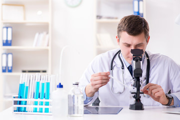 Male doctor looking at lab results in hospital