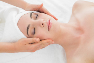 Fototapeta na wymiar Hands massaging womans face at beauty spa