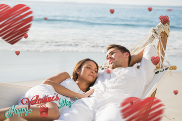 Peaceful couple relaxing on hammock against cute valentines message