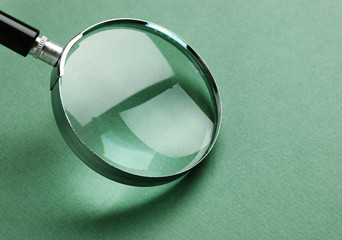 magnifying glass on green background