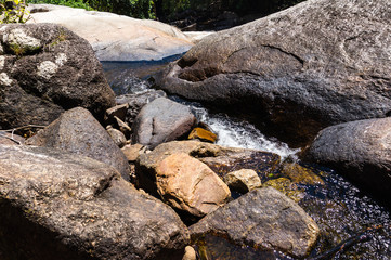 Mountain river with small waterfall in rainforest on tropical island, Malaysia