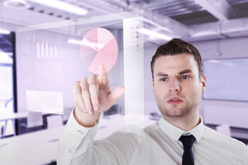 Young serious businessman pointing  against classroom