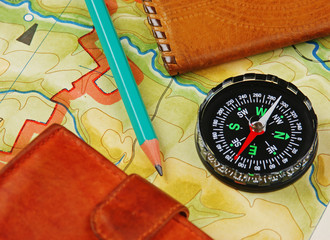 compass wallet and passport on the old map