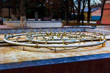 drained pool of fountain on the square. the inclusion of the fountain in the spring
