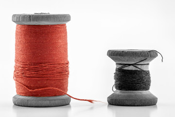 Reels or spools of multicolored sewing threads. Threads of all colors. Shallow depth of field. Close-up macro shot.