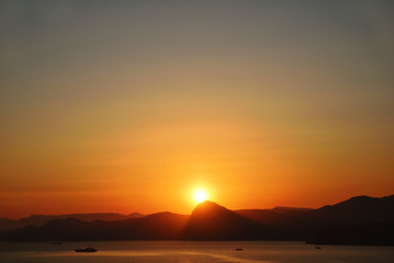 Naklejka na ściany i meble Scenic sunset on the mountain coast