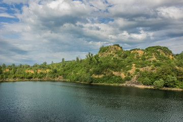 Fototapeta na wymiar quarry nature landscape with lake and hill