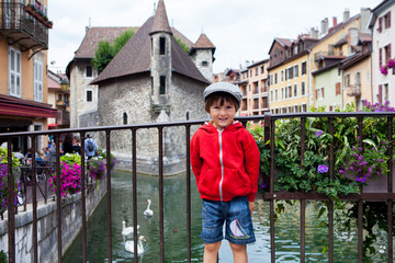 Sweet portrait of preschool boy in the town of Annecy, France, springtime