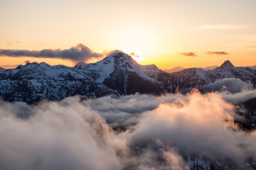 Striking and beautiful aerial landscape view of Canadian Mountains during a vibrant sunsetd. Taken North of Vancouver, British Columbia, Canada.