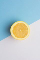 Ripe lemon in a cut on a diagonal white blue background
