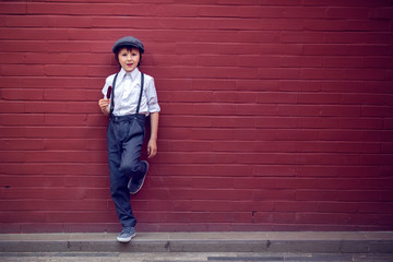 Little preschool boy, cute child, dressed in vintage style clothes, eating ice cream