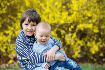 Adorable children, playing in the grass in park