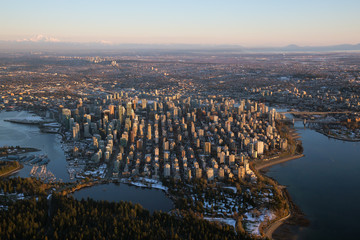 Naklejka premium Aerial view of Downtown City during a vibrant sunset. Taken in Vancouver, British Columbia, Canada.