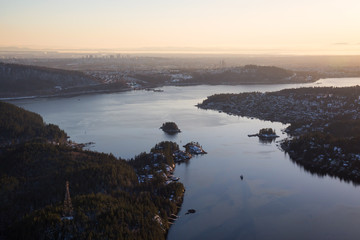 Aerial view of Deep Cove during a vibrant sunset. Taken in Vancouver, British Columbia, Canada.