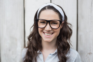 Cheerful trendy woman with stylish glasses posing