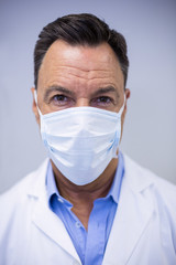 Dentist wearing surgical mask in dental clinic