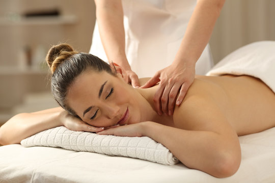 Relaxed lady receiving a massage in a spa