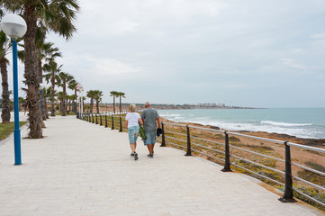Eldery People walking by seafront