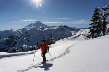 Fototapeta na wymiar Adventurous man is snowshoeing in the alpine. Taken in Artist Point, Northeast of Seattle, Washington, United States of America.