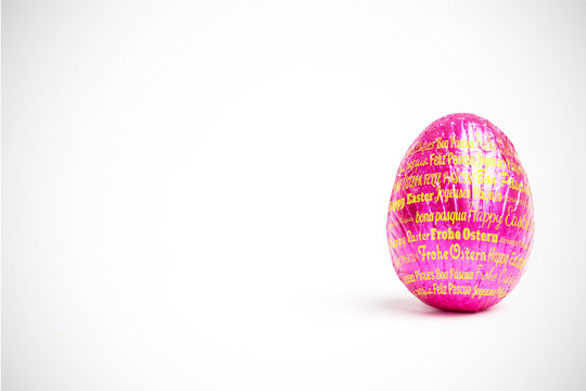 Happy easter in different languages against pink easter egg