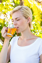 Attractive blonde woman drinking tea