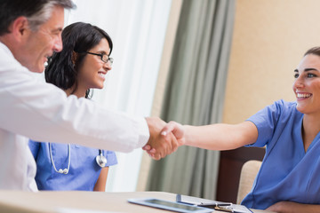 Nurse and doctor shaking hands