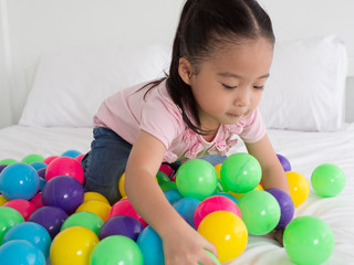 Fototapeta na wymiar young Asian Kid playing colorful ball.