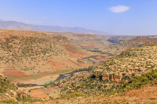 Malealea street village near mountain and cultivation field