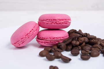 Obraz na płótnie Canvas Cake macaroon pink pastel color with coffee bean on white plate background
