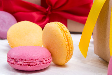 Cake macaroon on gift red and yellow ribbon background