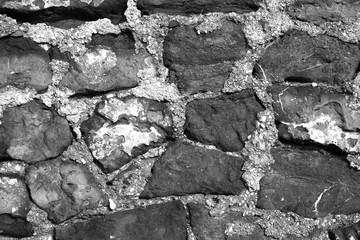 Stone wall. Ancient stonework. The texture of the stone.