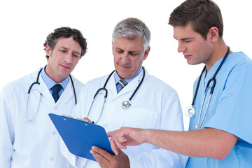 Doctors and nurse discussing over notes