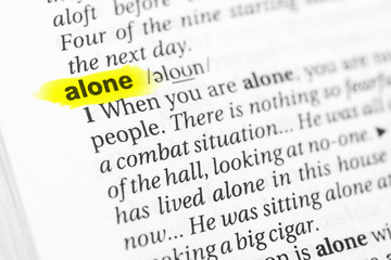 Highlighted English word "alone" and its definition in the dictionary