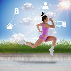 Fototapeta na wymiar Fit brunette running and jumping against apps in blue sky