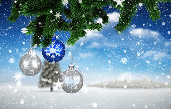Composite image of christmas decorations against fir tree in snowy landscape