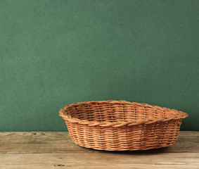 empty wicker basket on an old wooden table