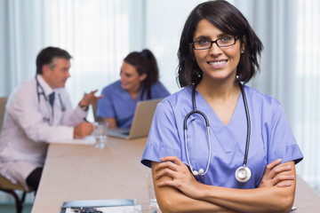 Smiling nurse with arms crossed