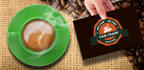 Hand showing card against coffee beans and burlap sack