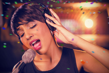 Woman singing in bar against flying colours