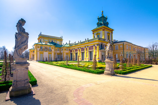 The royal Wilanow Palace in Warsaw, Poland, with gardens, statues and river around it.