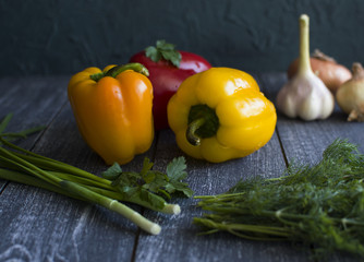 Background with red and yellow peppers, green onion, salad, garlic