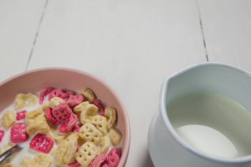 Bowl of honeycomb cereal and milk on wooden table