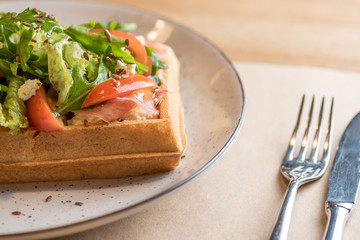 Homemade Belgian Waffle with salad Iceberg, tomatoes and ham