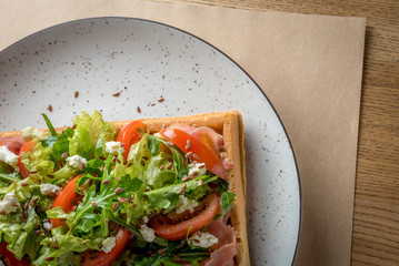 Homemade Belgian Waffle with salad Iceberg, tomatoes and ham