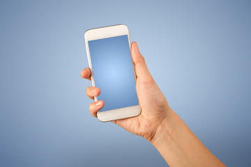 Female fingers touching blank smartphone