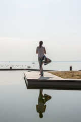 women on seaside meditating in yoga pose