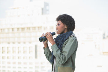 Curious casual model holding binoculars