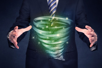 Bright green tornado in the hands of a businessman 
